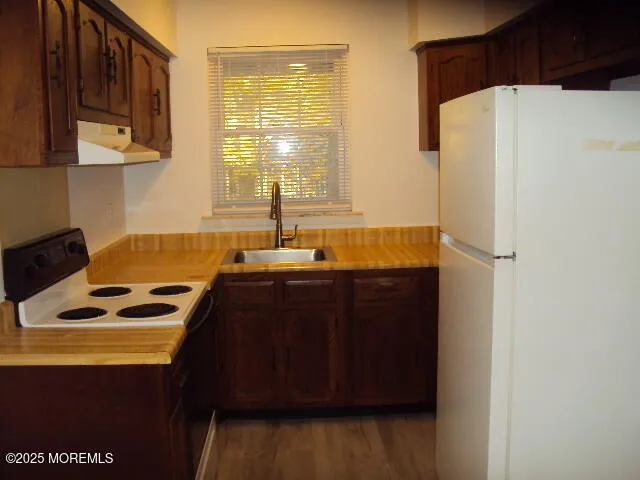 a kitchen with a refrigerator and a stove
