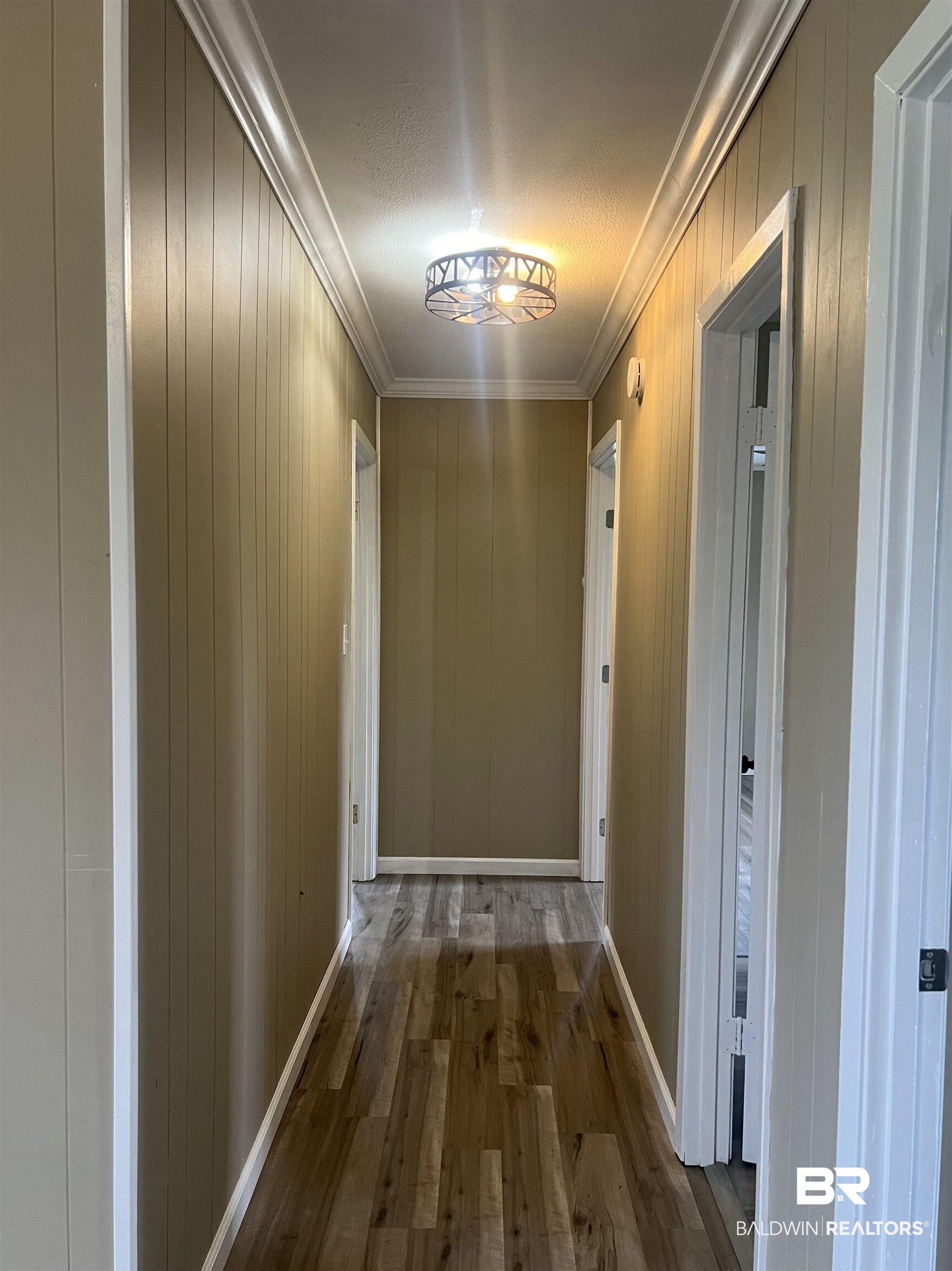 508 Freemanville Drive Atmore, AL 36502 - Photo 14 of 27 Hall with ornamental molding, a textured ceiling, and hardwood / wood-style flooring