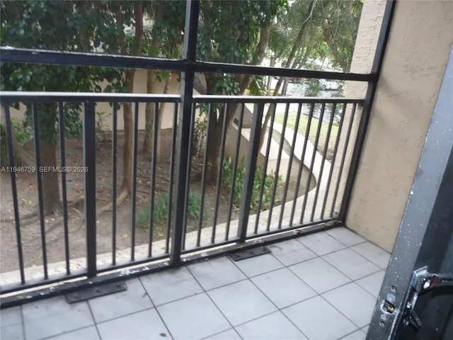 a view of a balcony with a tree