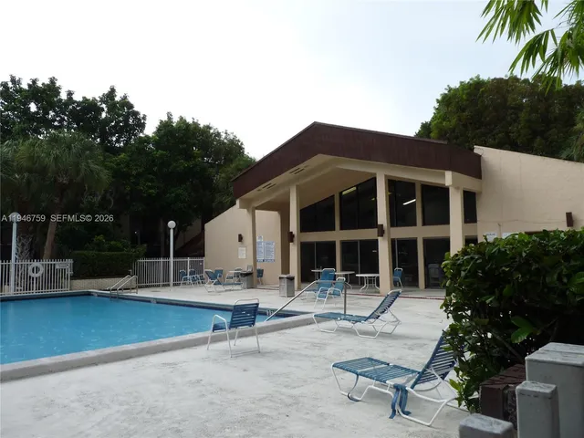 a front view of a house with a tree