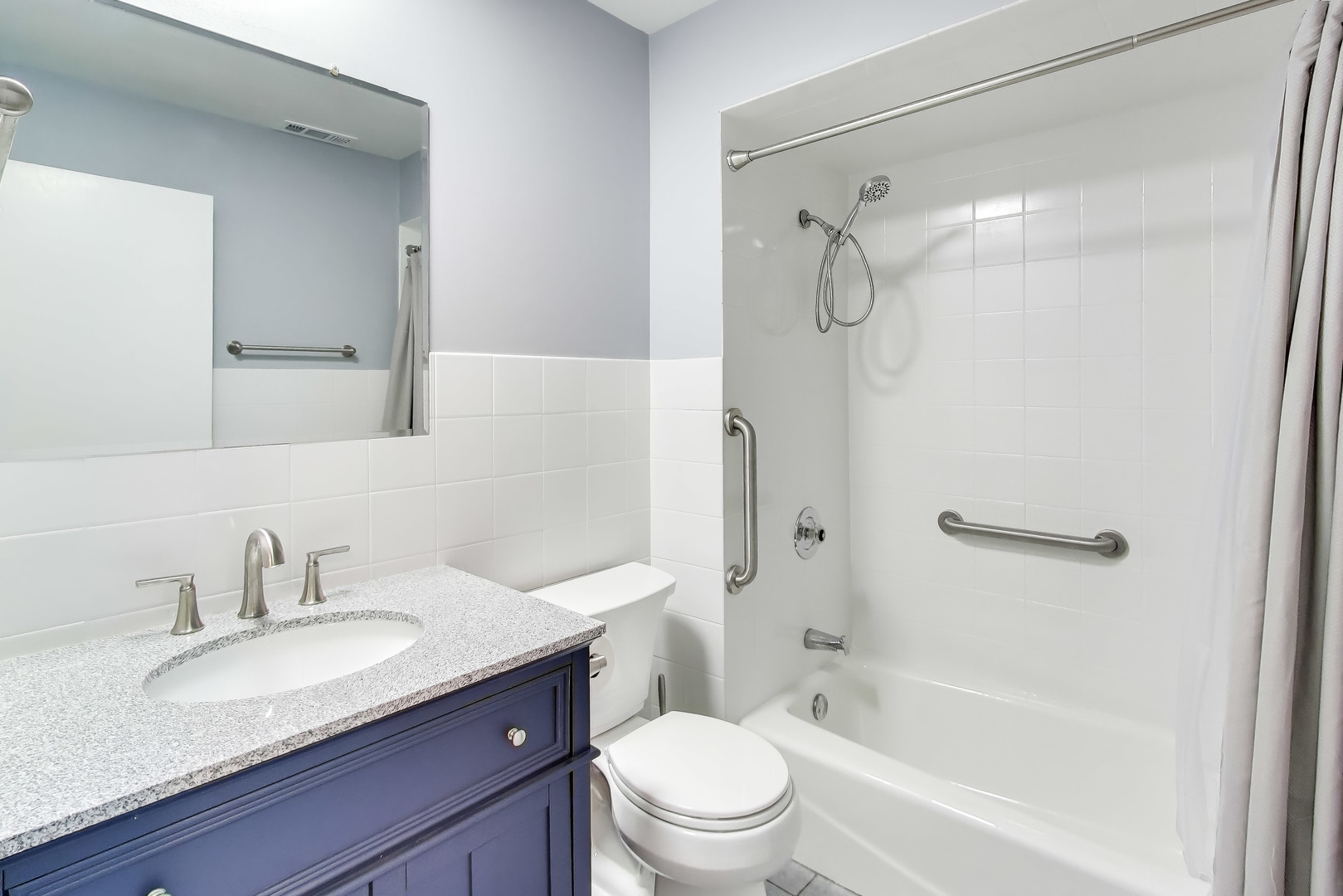 6820 West Raven Street, Unit 1B Chicago, IL 60631 - Photo 20 of 25 a bathroom with a granite countertop sink toilet mirror and shower