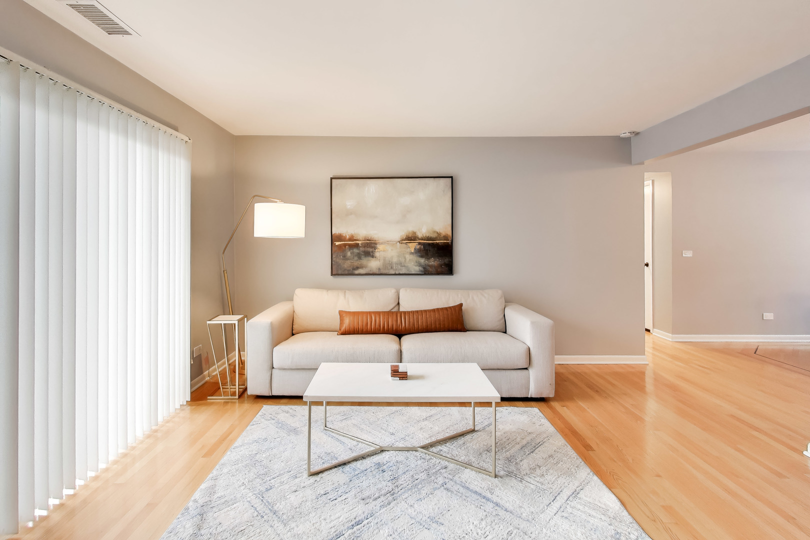 6820 West Raven Street, Unit 1B Chicago, IL 60631 - Photo 7 of 25 a living room with a couch and a large window