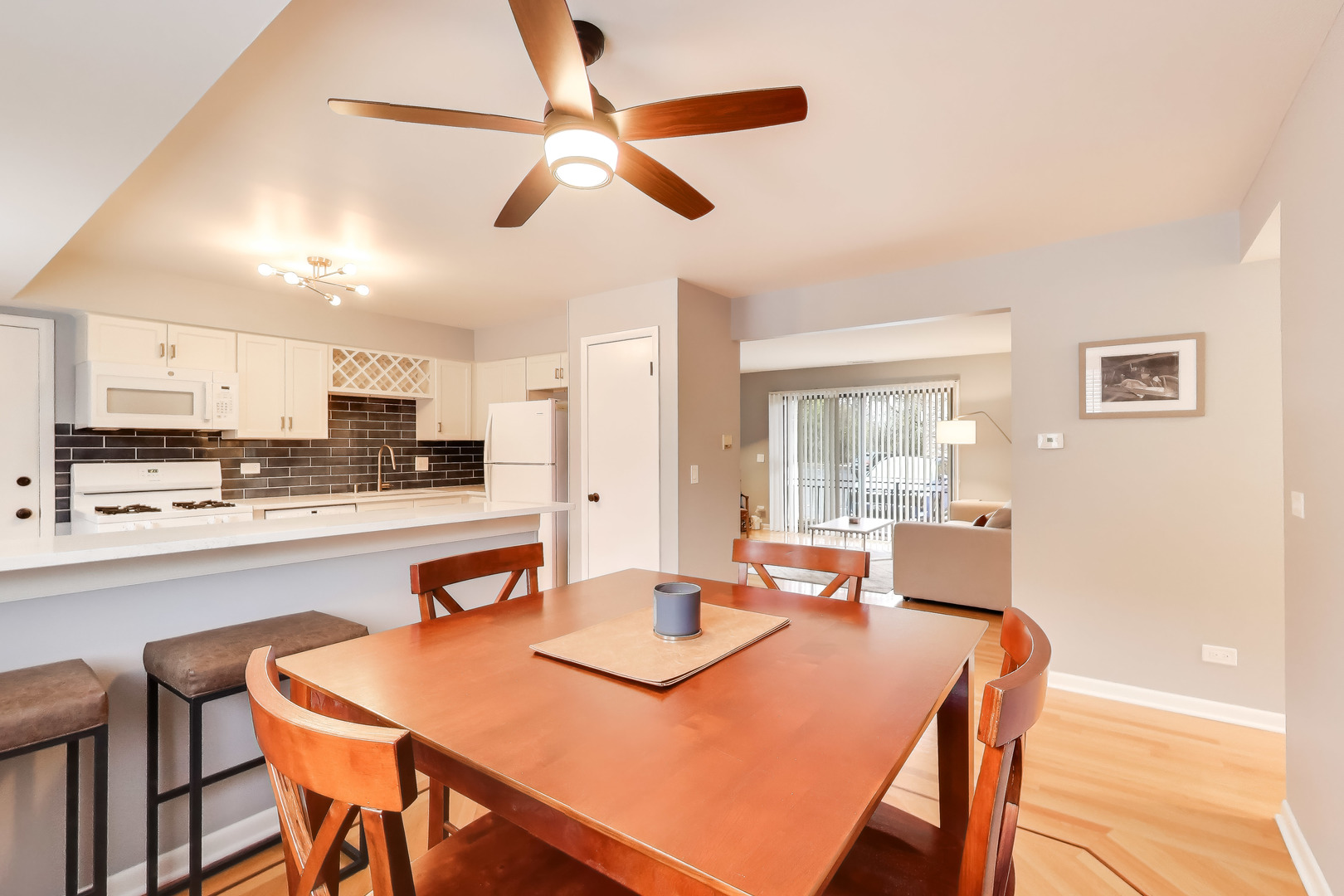 6820 West Raven Street, Unit 1B Chicago, IL 60631 - Photo 10 of 25 a dining room with stainless steel appliances kitchen island granite countertop a dining table and chairs