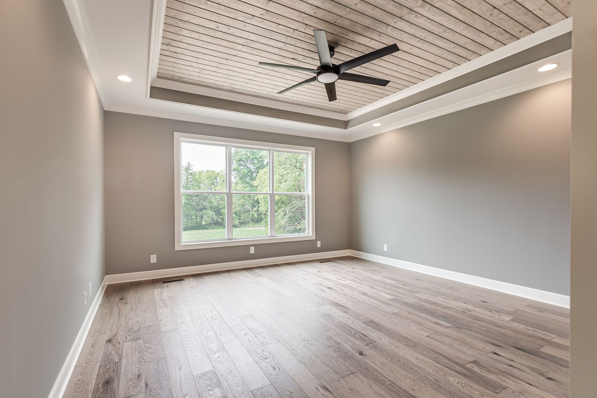 1581 Phillips Road Lebanon, TN 37087 - Photo 21 of 36 an empty room with wooden floor ceiling fan and windows