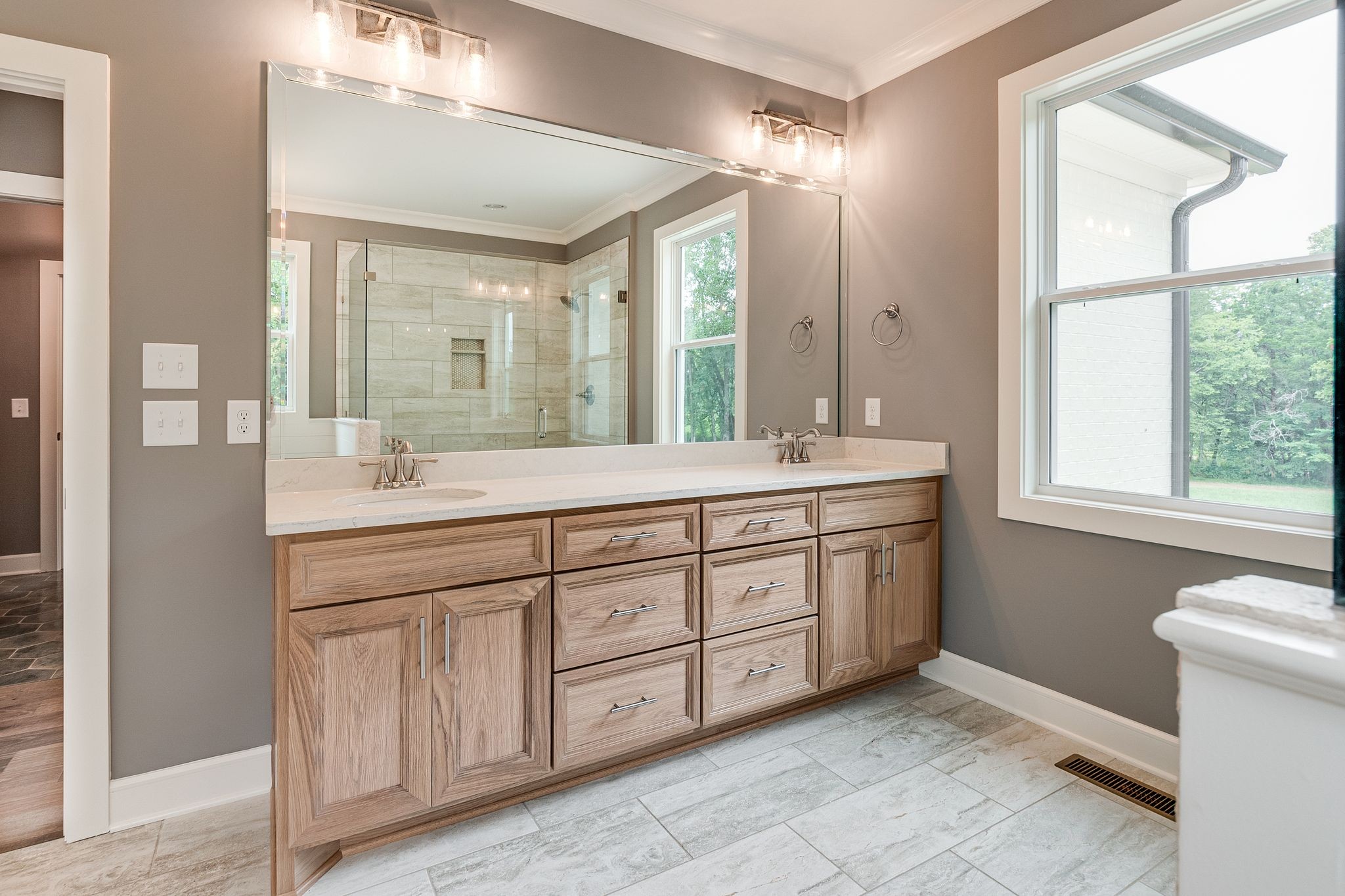 1581 Phillips Road Lebanon, TN 37087 - Photo 26 of 36 a spacious bathroom with a double vanity sink a large mirror and a bathtub