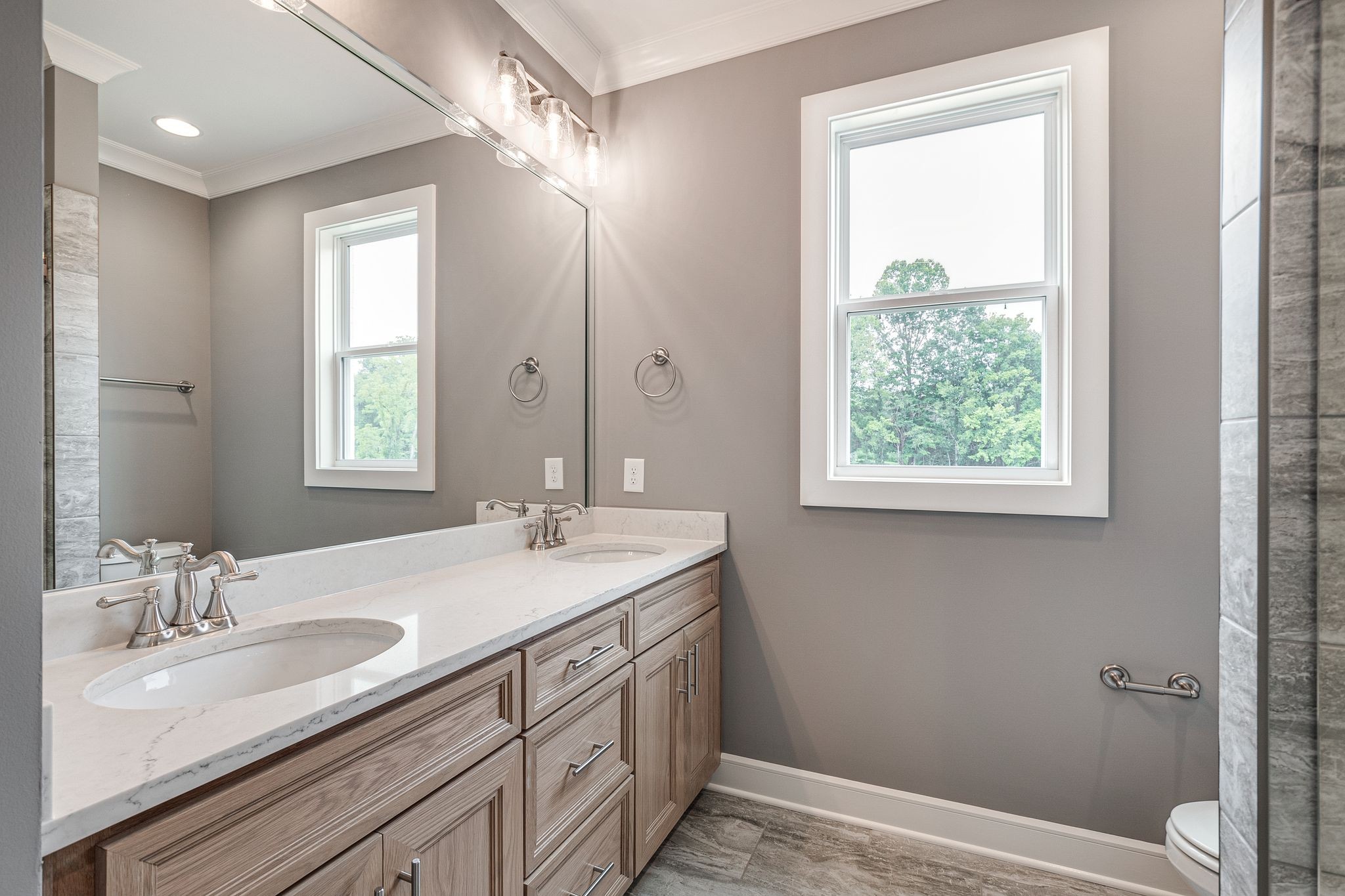 1581 Phillips Road Lebanon, TN 37087 - Photo 29 of 36 a bathroom with a granite countertop sink a large mirror a and a window
