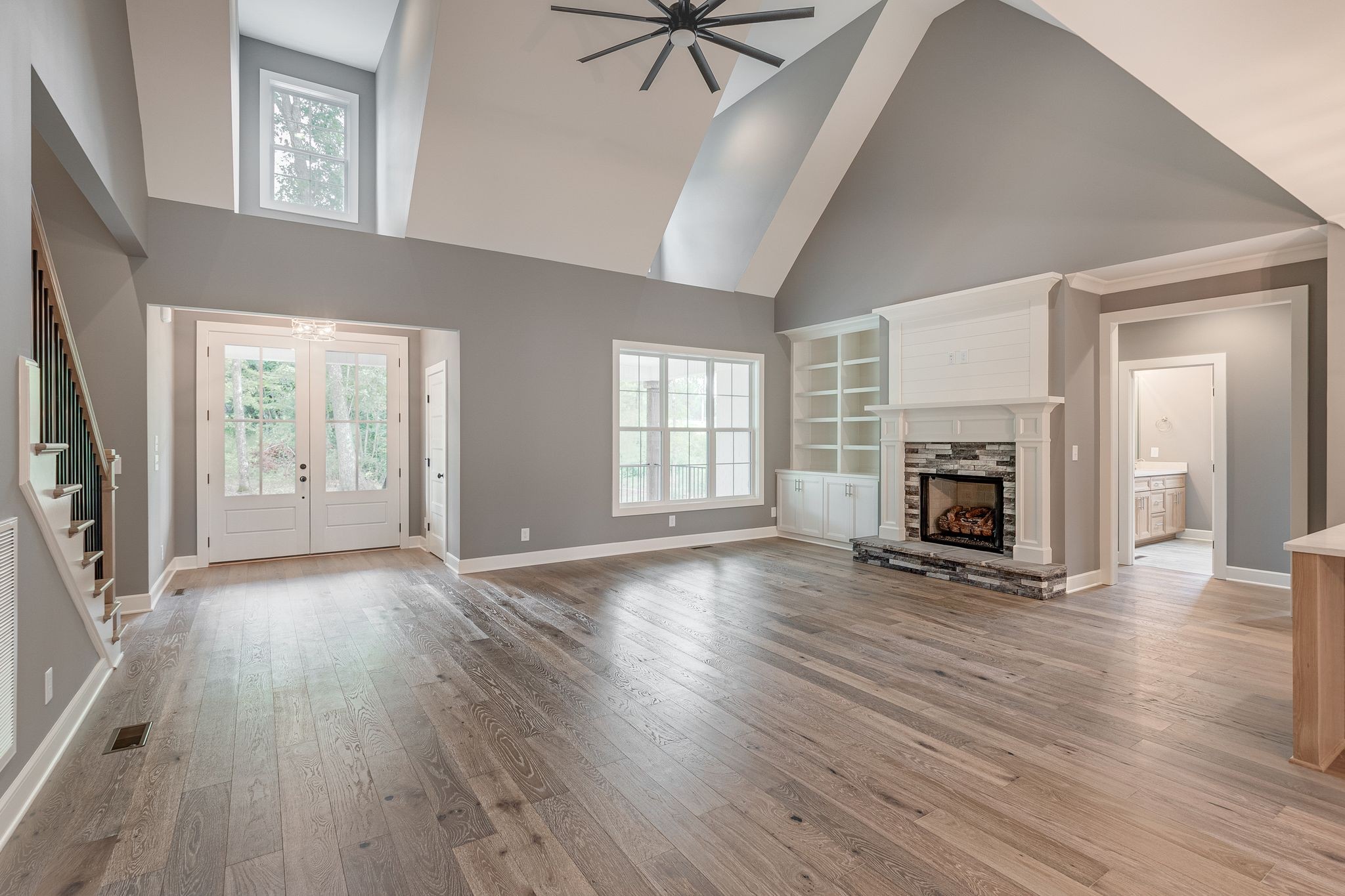 1581 Phillips Road Lebanon, TN 37087 - Photo 7 of 36 an empty room with wooden floor a fireplace and windows