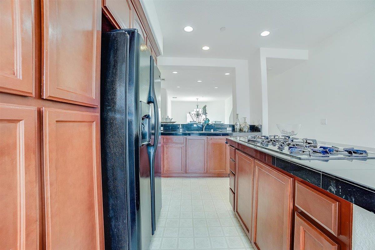49030 Meadowfaire Common Fremont, CA 94539 - Photo 15 of 52 a kitchen with stainless steel appliances granite countertop a refrigerator and a sink