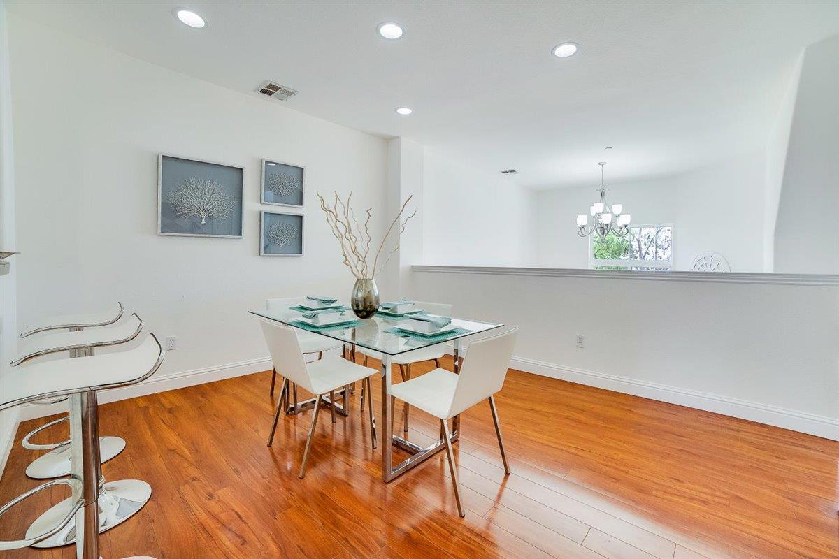 49030 Meadowfaire Common Fremont, CA 94539 - Photo 18 of 52 a view of a dining room with furniture and wooden floor