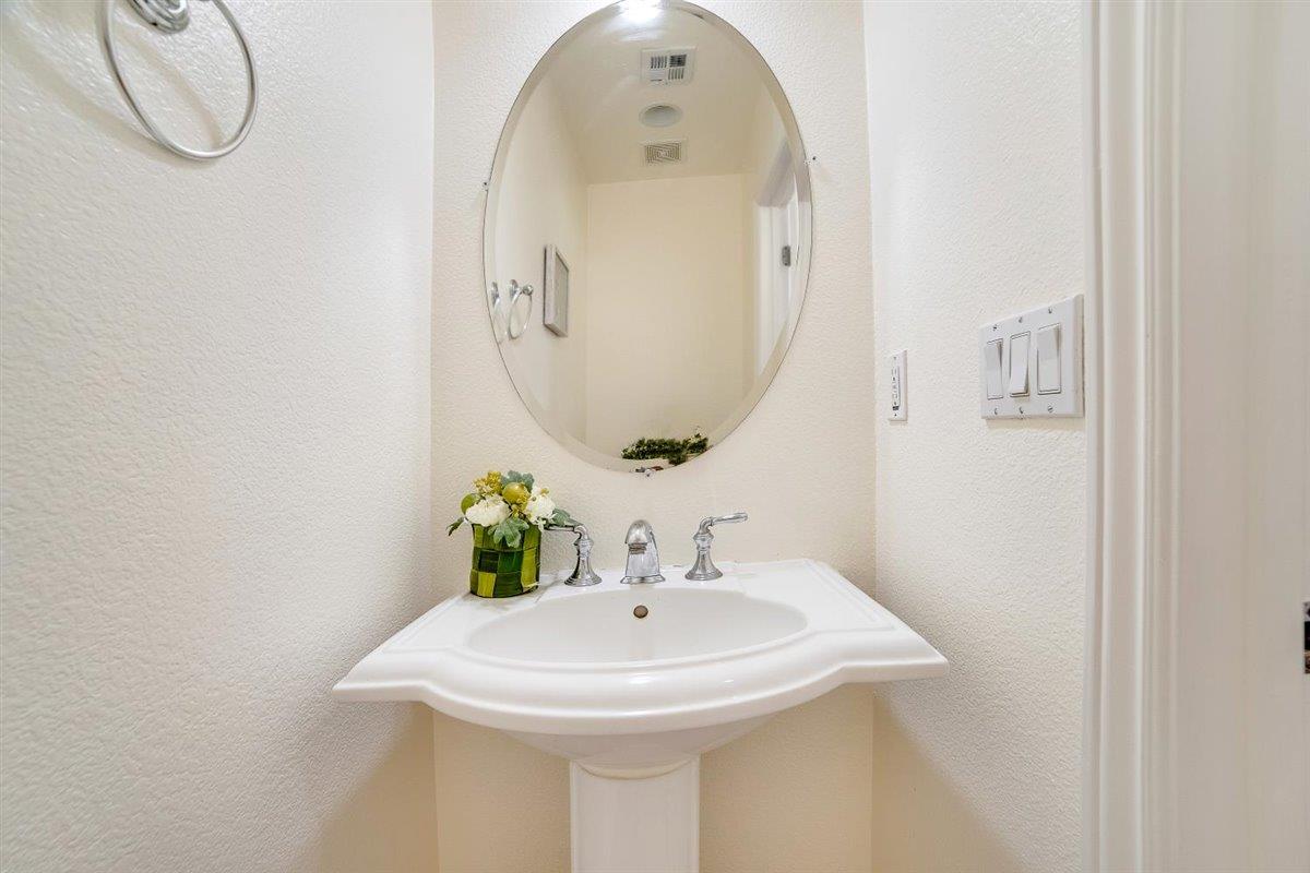 49030 Meadowfaire Common Fremont, CA 94539 - Photo 23 of 52 a bathroom with a sink and mirror