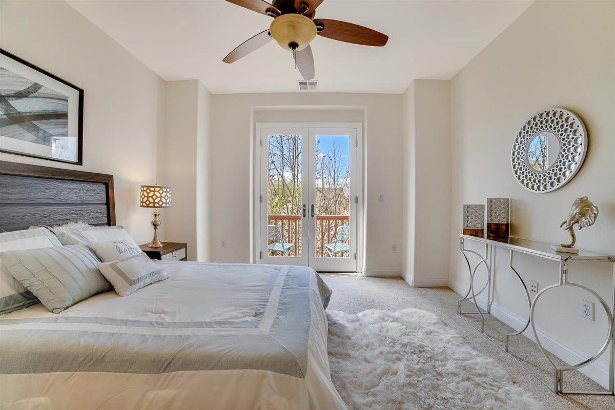 49030 Meadowfaire Common Fremont, CA 94539 - Photo 26 of 52 a spacious bedroom with a large bed and a chandelier