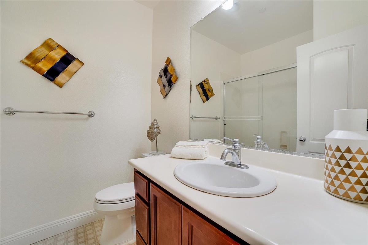 49030 Meadowfaire Common Fremont, CA 94539 - Photo 29 of 52 a bathroom with a sink mirror and toilet