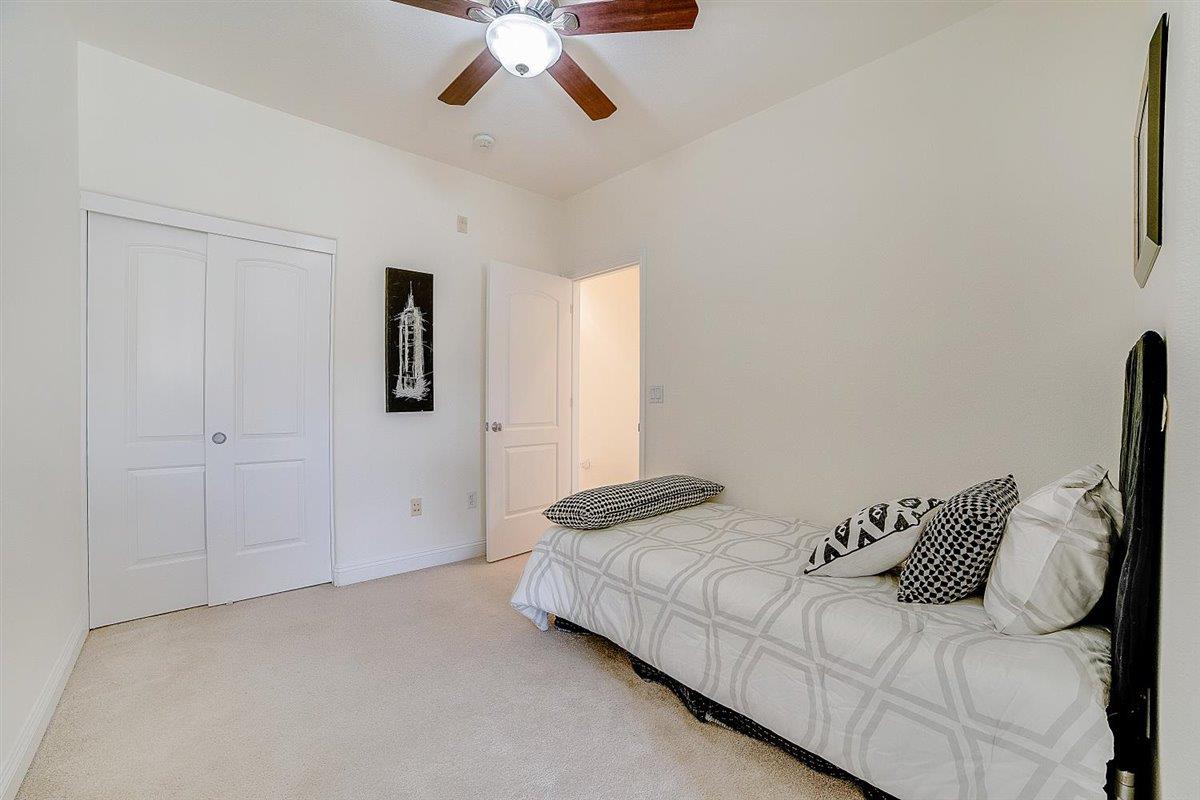 49030 Meadowfaire Common Fremont, CA 94539 - Photo 32 of 52 a bedroom with a bed and a chandelier