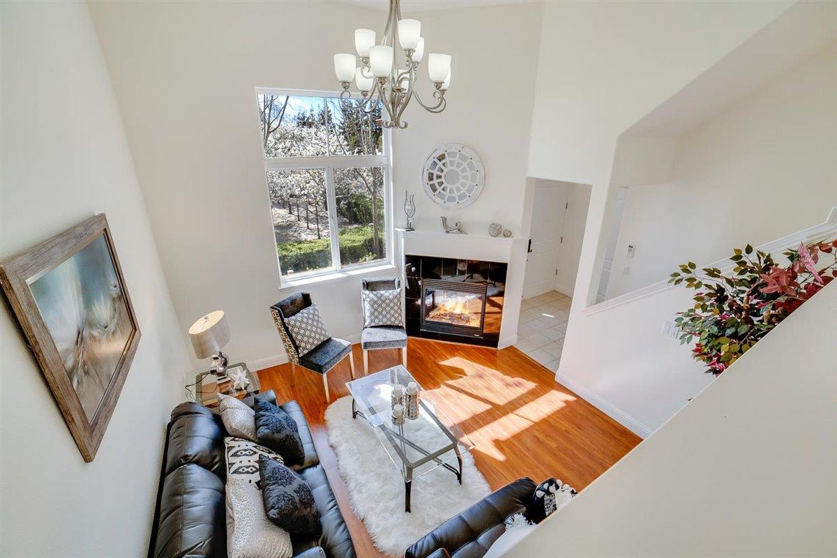 49030 Meadowfaire Common Fremont, CA 94539 - Photo 37 of 52 a living room with furniture chandelier and a fireplace