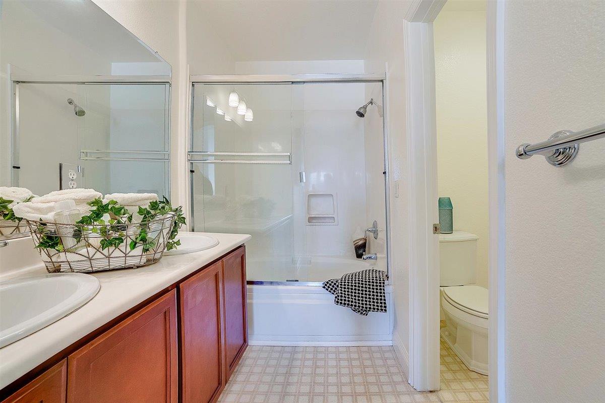 49030 Meadowfaire Common Fremont, CA 94539 - Photo 8 of 52 a bathroom with a granite countertop shower a sink and toilet