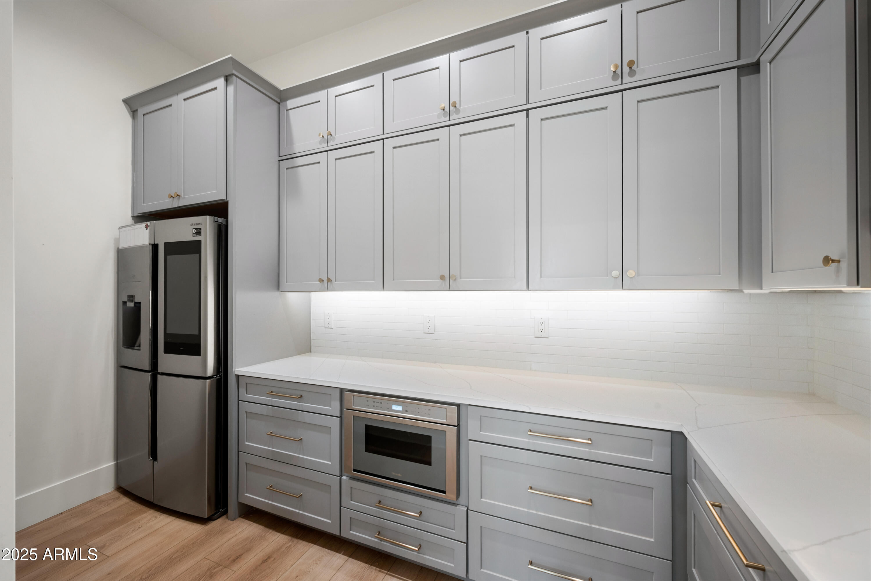 4352 East Santa Rosa Place Gilbert, AZ 85234 - Photo 11 of 53 a kitchen with white cabinets and stainless steel appliances