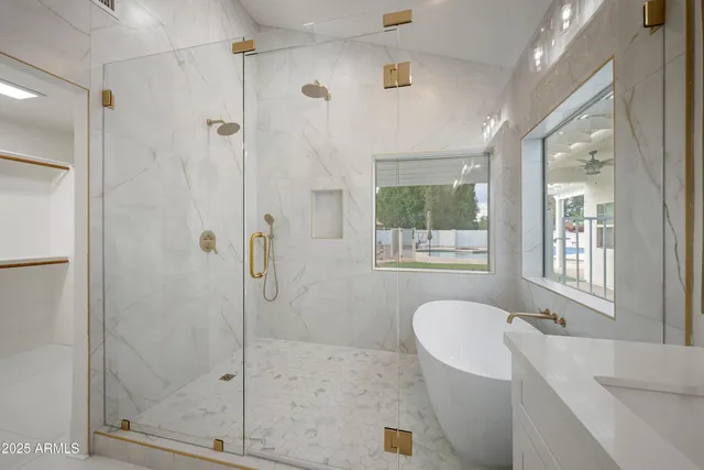 a bath room with a bath tub and shower