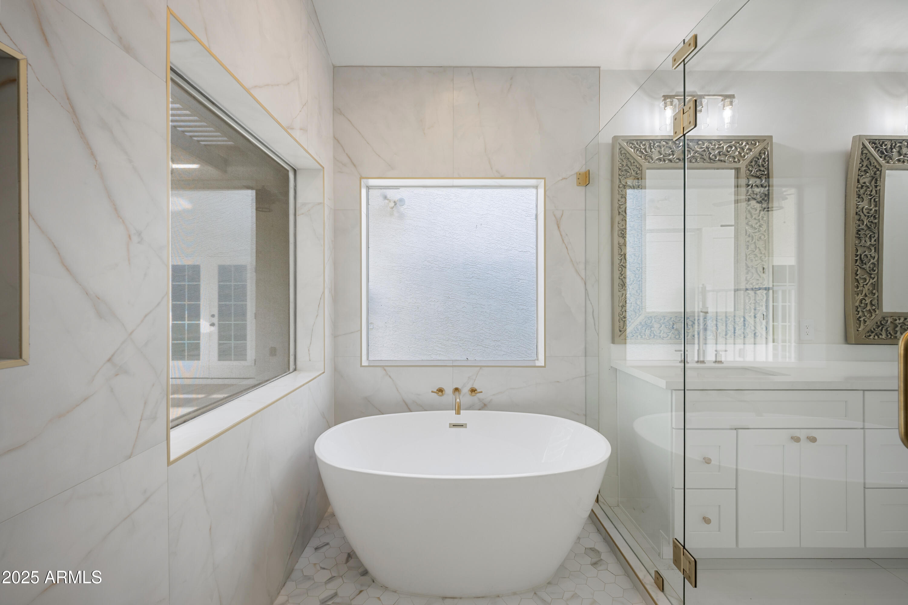 4352 East Santa Rosa Place Gilbert, AZ 85234 - Photo 18 of 53 a white bath tub sitting next to a white sink