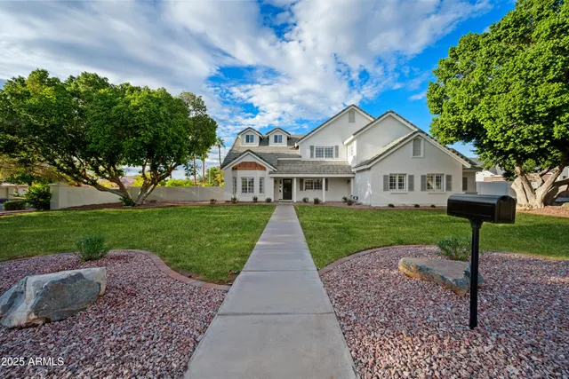 a view of house with a yard and garden