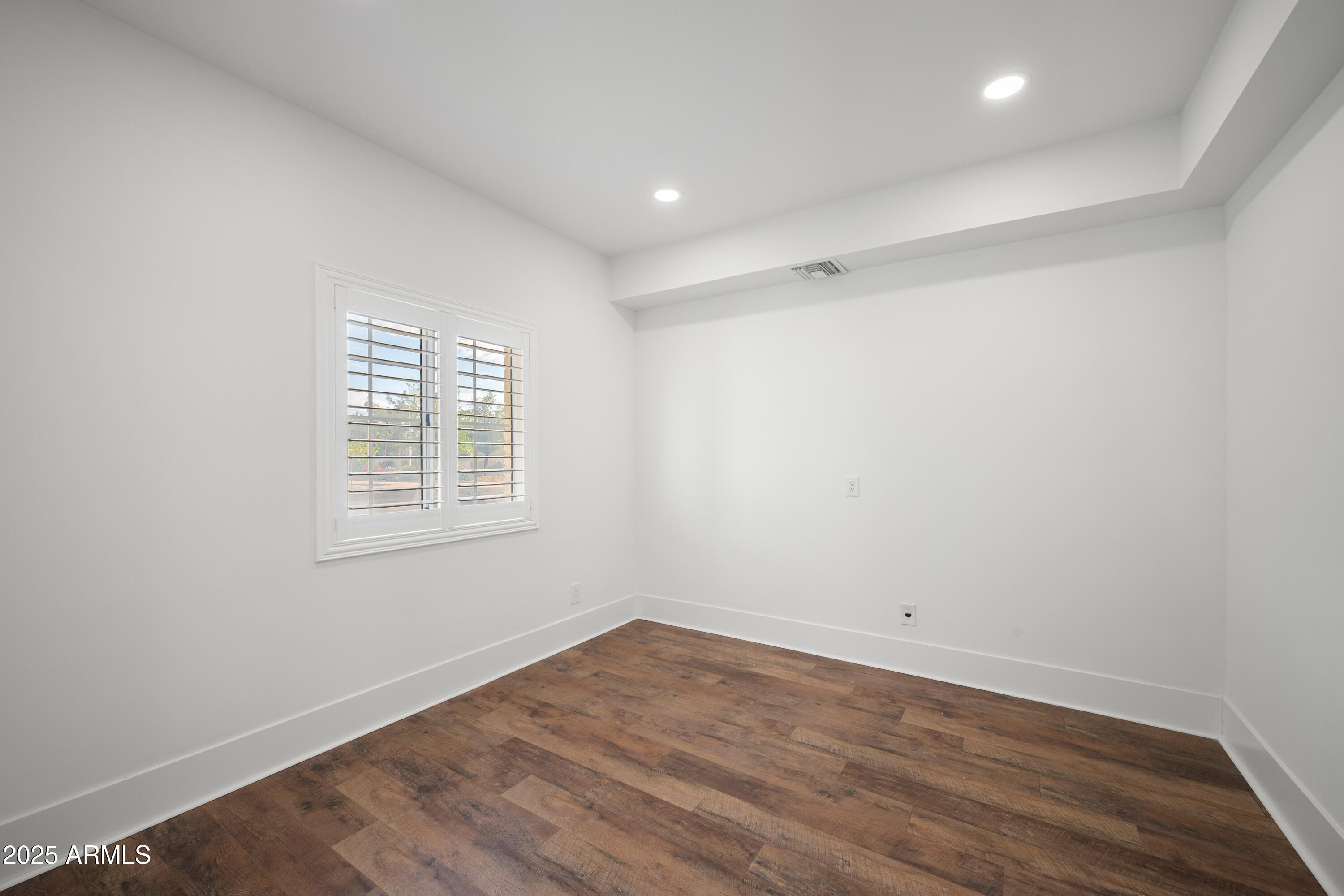 4352 East Santa Rosa Place Gilbert, AZ 85234 - Photo 26 of 53 an empty room with wooden floor and windows