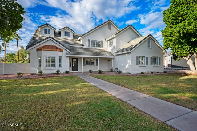 a front view of a house with a garden