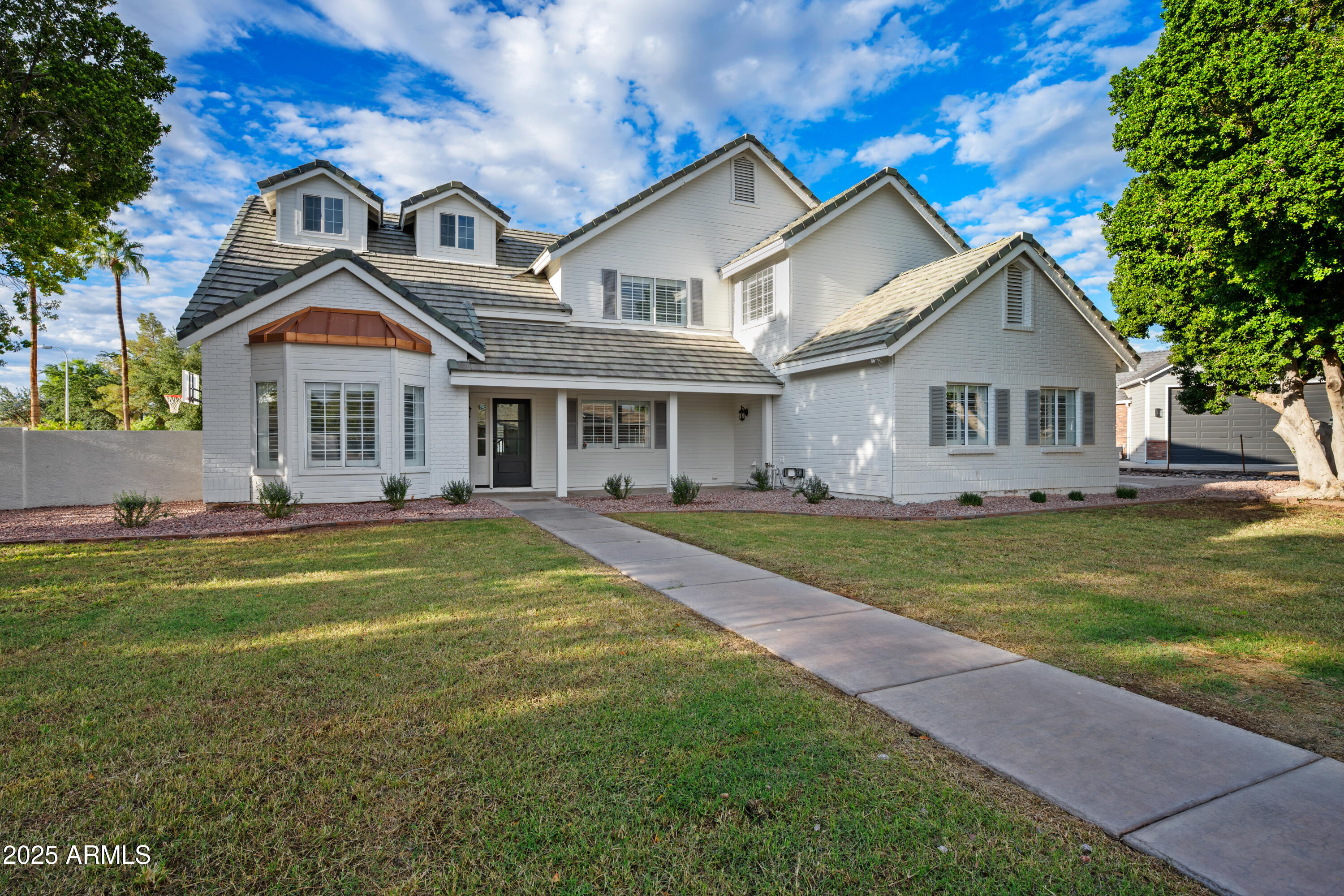 4352 East Santa Rosa Place Gilbert, AZ 85234 - Photo 37 of 53 a front view of a house with a garden