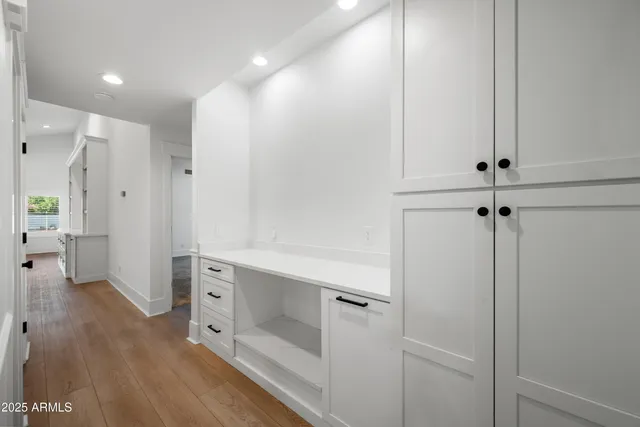 an empty room with windows and fireplace