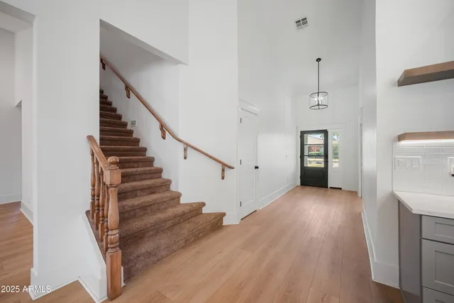 a view of entryway and hall with wooden floor