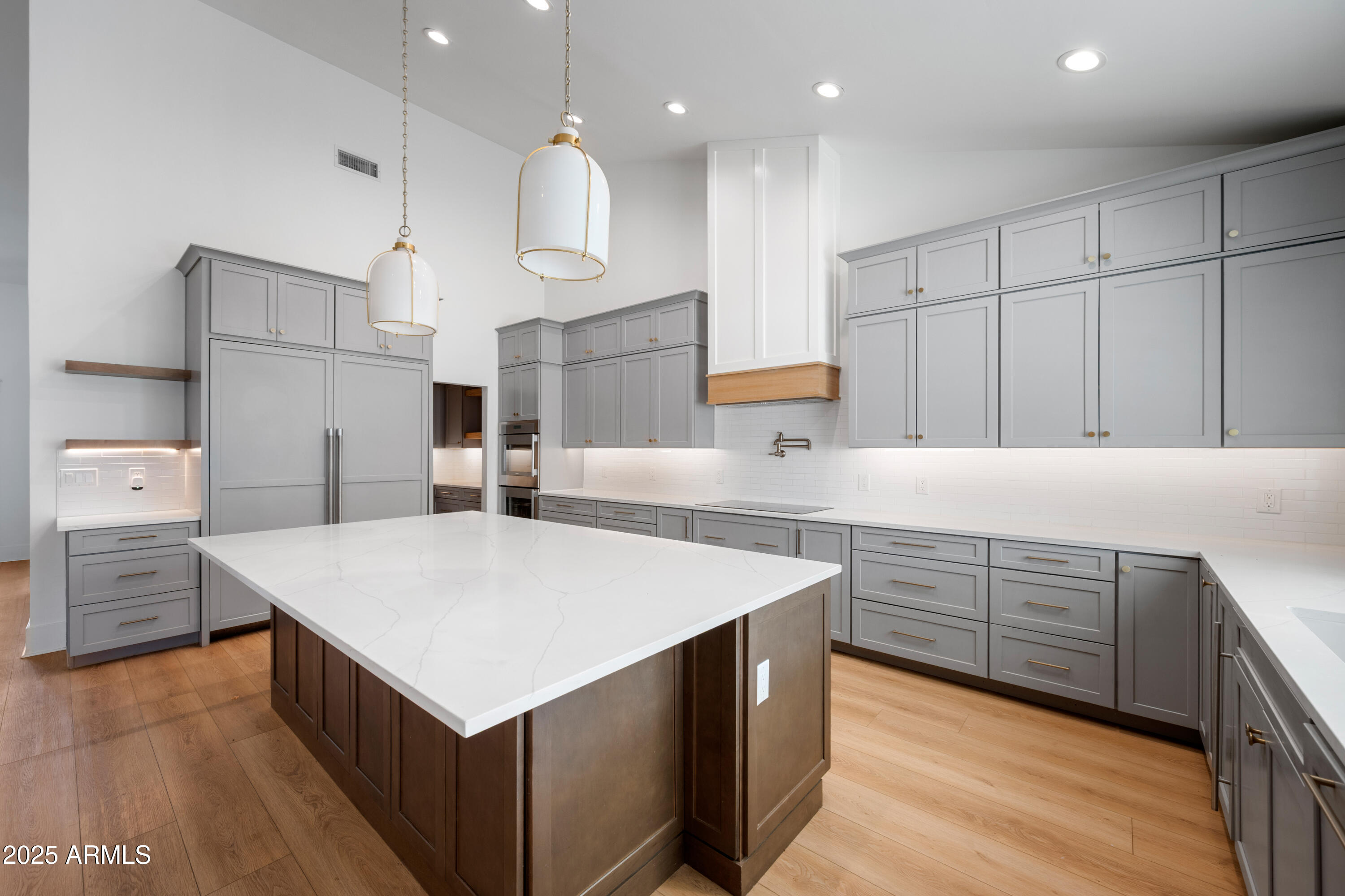 4352 East Santa Rosa Place Gilbert, AZ 85234 - Photo 9 of 53 a kitchen that has a lot of cabinets and wooden floor