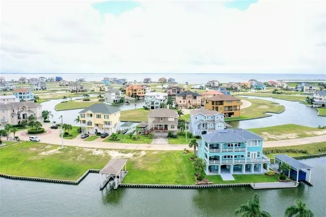 an aerial view of residential houses with outdoor space and swimming pool