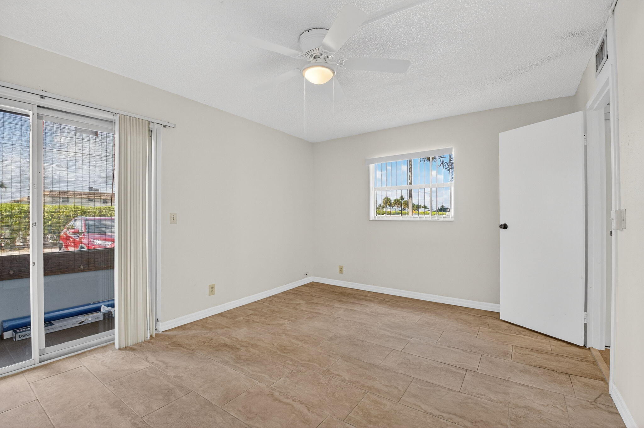 51 Flanders B Delray Beach, FL 33484 - Photo 13 of 42 wooden floor in an empty room and a window