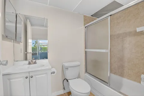 a bathroom with a toilet a sink and a shower