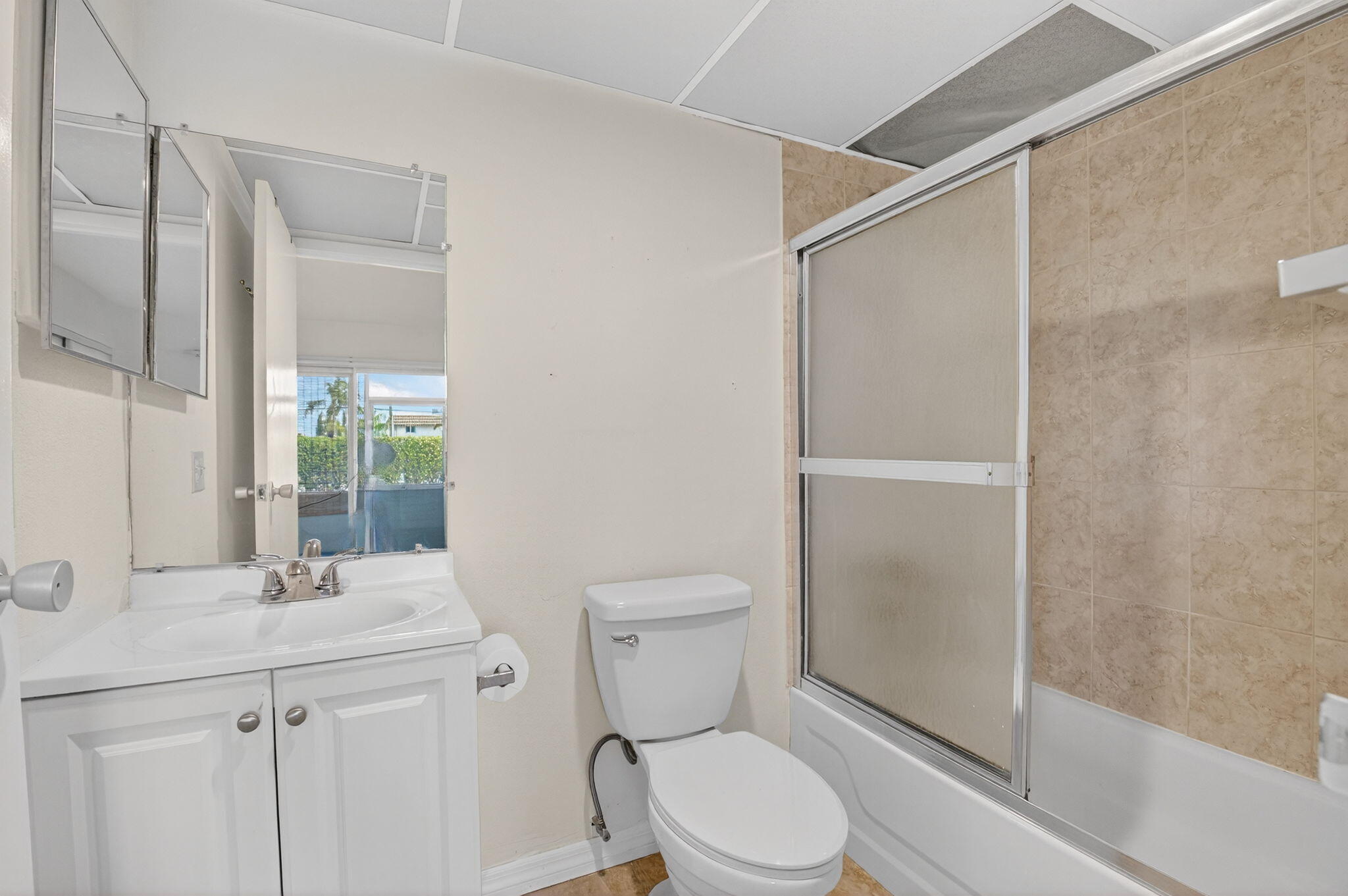 51 Flanders B Delray Beach, FL 33484 - Photo 15 of 42 a bathroom with a toilet a sink and a shower
