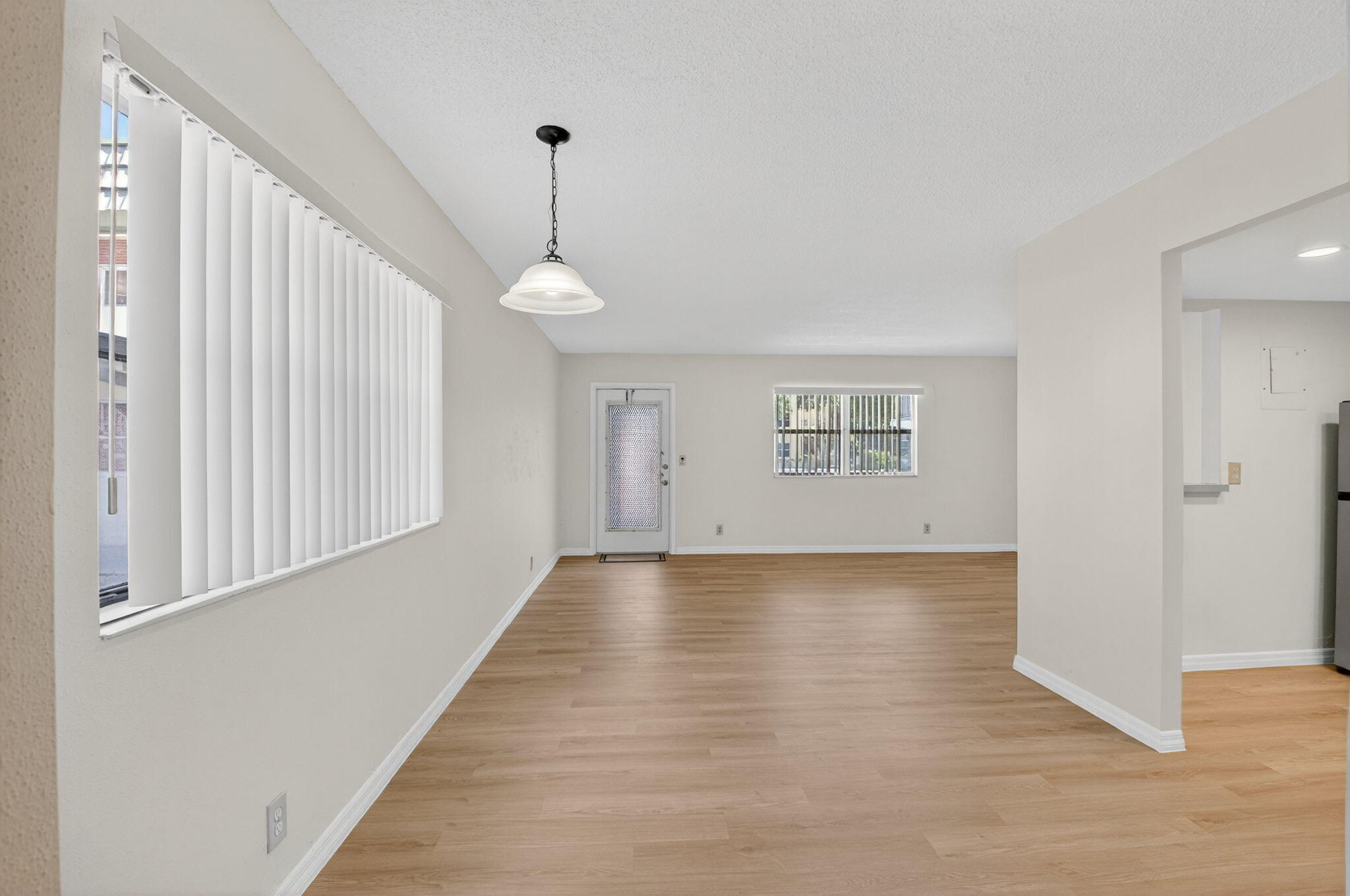 51 Flanders B Delray Beach, FL 33484 - Photo 9 of 42 a view of an empty room with wooden floor and a window