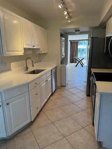 a kitchen with a sink cabinets and appliances