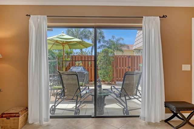 a dining room table with glass top table and chairs