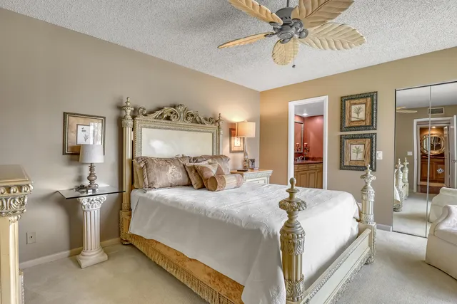 a bedroom with a bed and ceiling fan