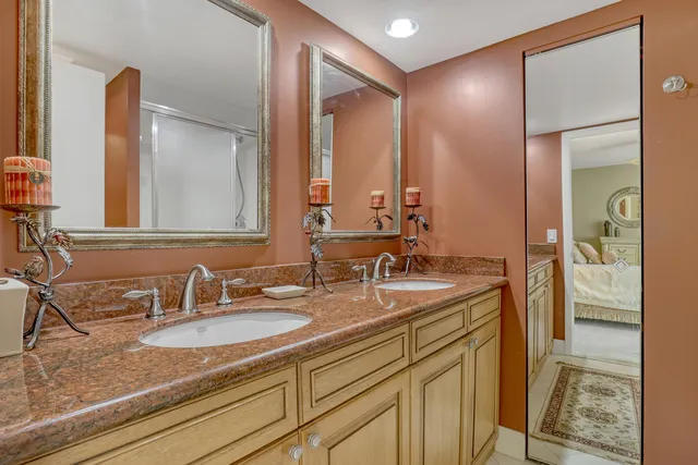 a bathroom with a sink double vanity and a mirror
