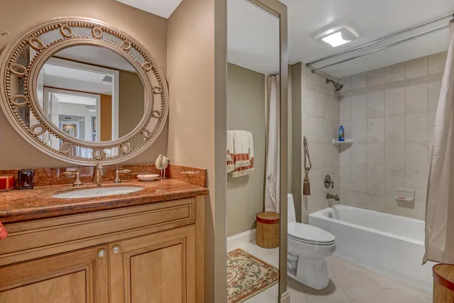 a bathroom with a toilet a sink and a mirror