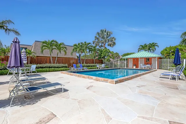 a view of a house with a swimming pool and a yard