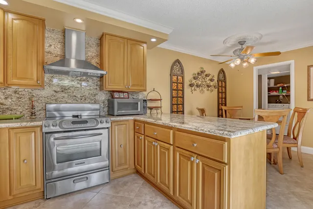 a kitchen with stainless steel appliances granite countertop a stove and a sink