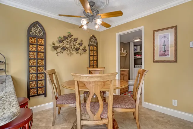 a view of a dining room with furniture and a chandelier
