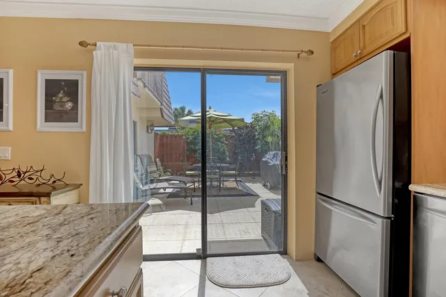 a kitchen with refrigerator and window