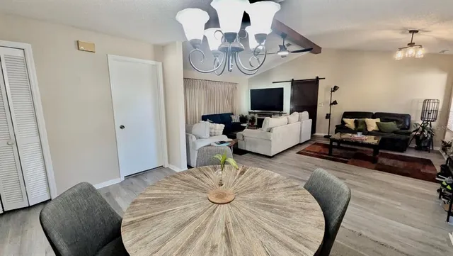 a living room with furniture or chandelier and a flat screen tv