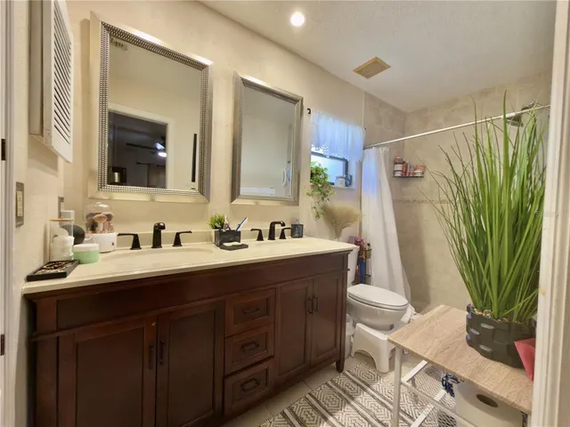 a bathroom with double vanity sink and a mirror