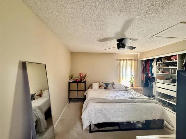 a bedroom with a bed and a flat tv screen