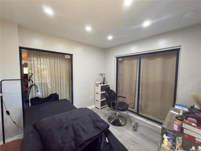 a view of a workspace with furniture and a window