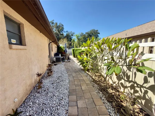 a path view of a house with a yard