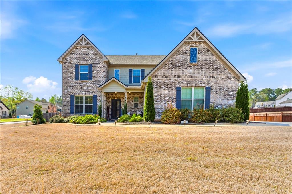 a front view of a house with a yard