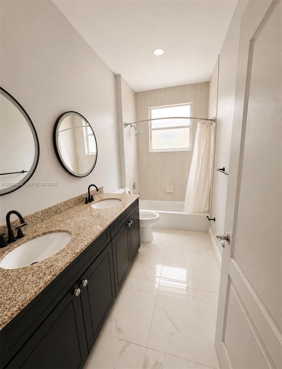 354 Mallard Road, Unit O Weston, FL 33327 - Photo 11 of 29 a bathroom with a granite countertop sink a mirror and a bathtub